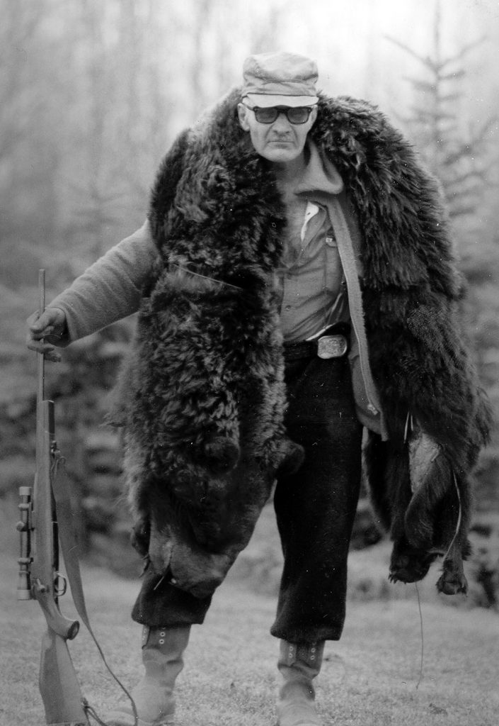 Gene Walters packing grizzly hide